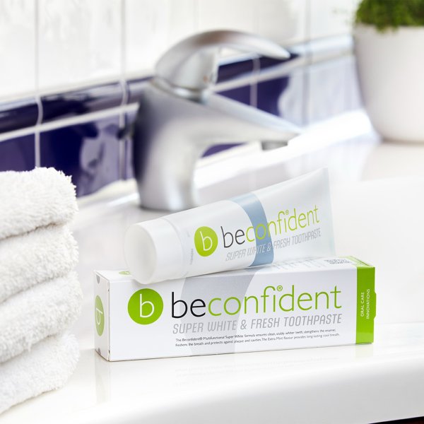 Beconfident Super Whitening Fresh Toothpaste packaging and toothpaste laying down on bathroom counter